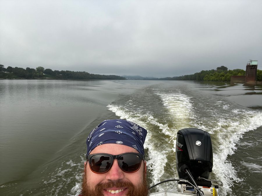 Selfie on a boat with the wake and river behind